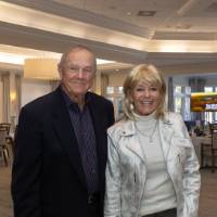 Sandee Frank and gentleman smiling for camera